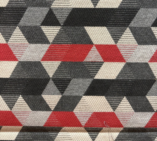 Geometric patterned fabric with red, black, and beige triangles.